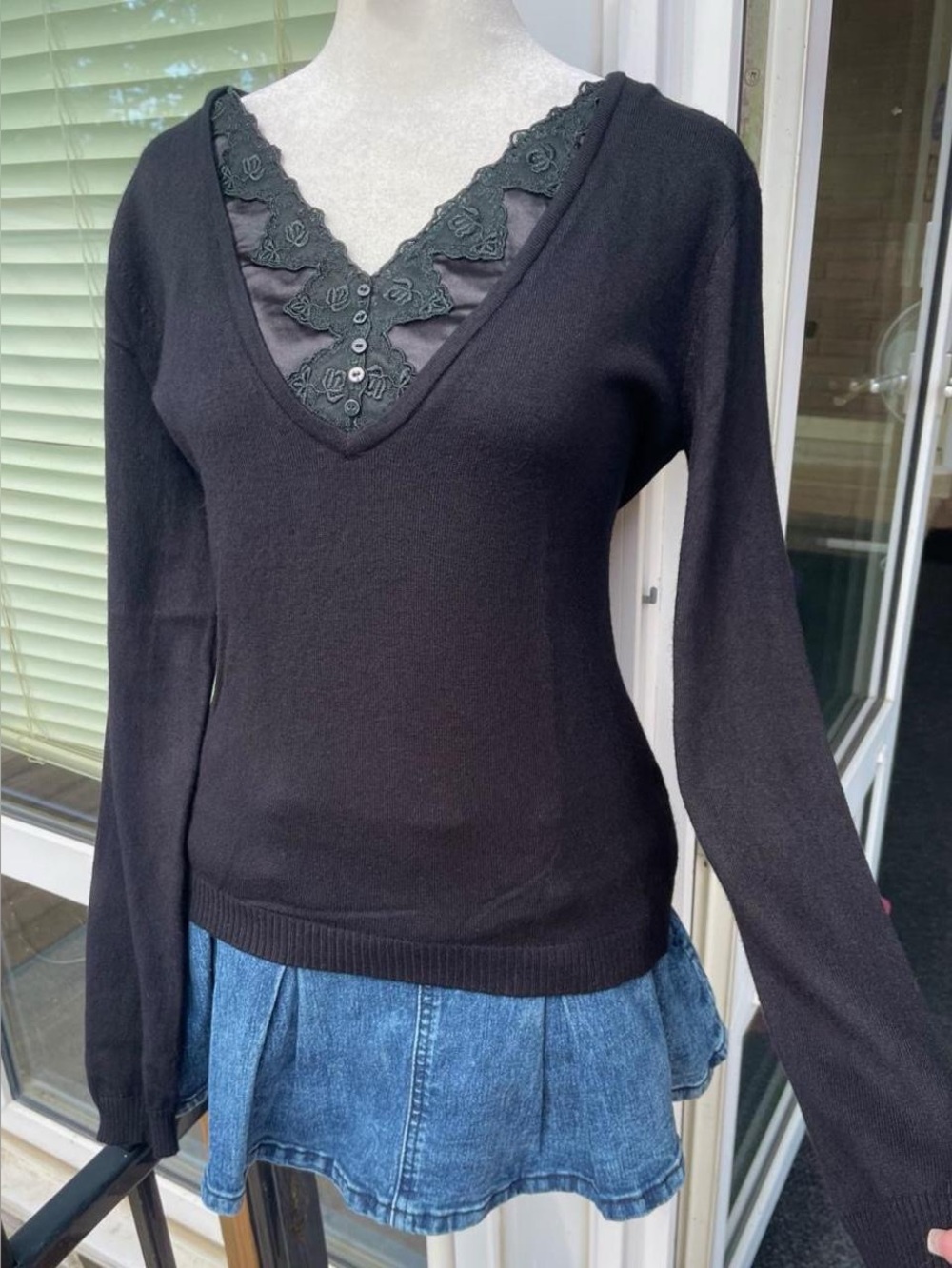 Black fitted sweater with embroidered and satin details